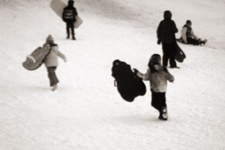 running up hill carrying sleds