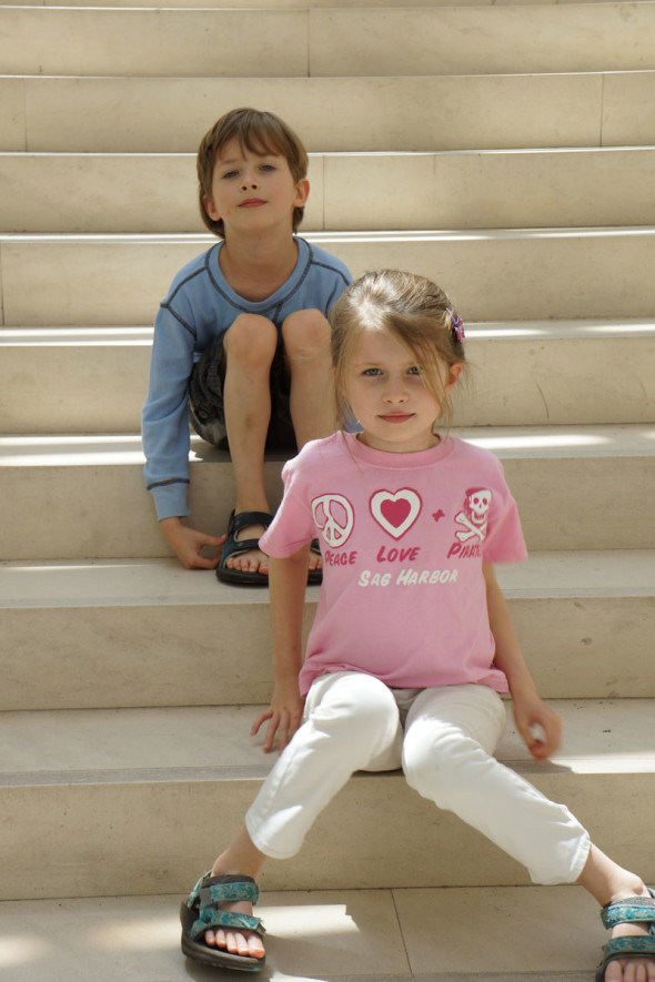 Luce sitting ahead of Theo on steps