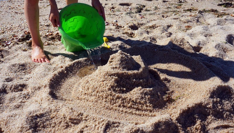 Pouring water sandcastle moat