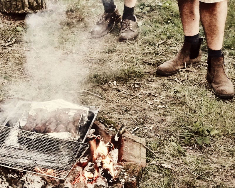 feet next to campfire