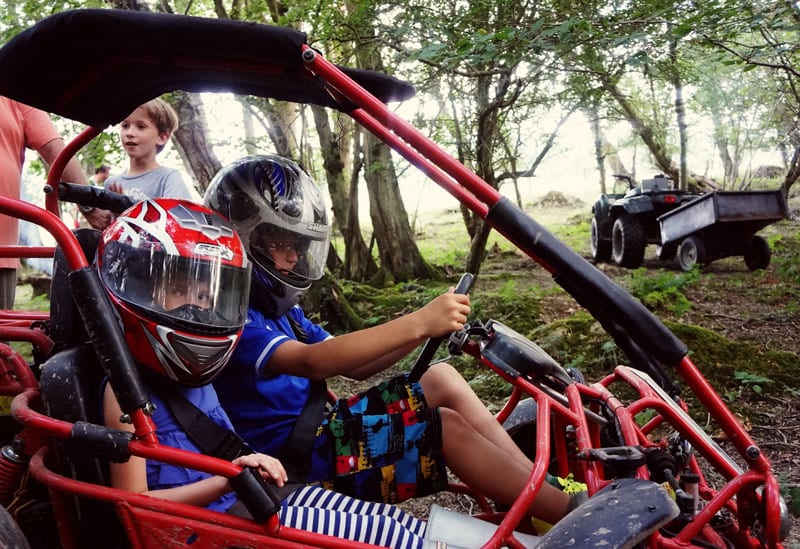 off road go kart with kids in woods