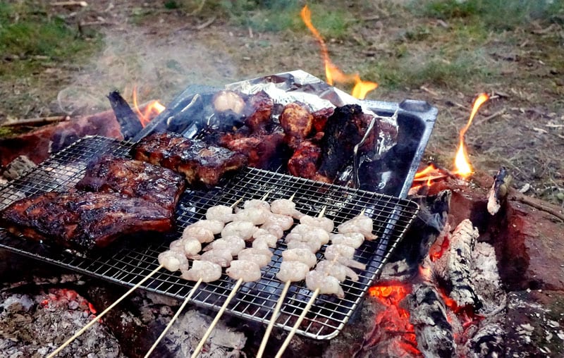 ribs chicken shrimp cooking on campfire