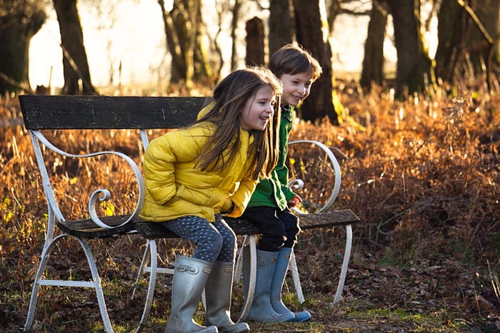 Luce and Theo on bench laughing