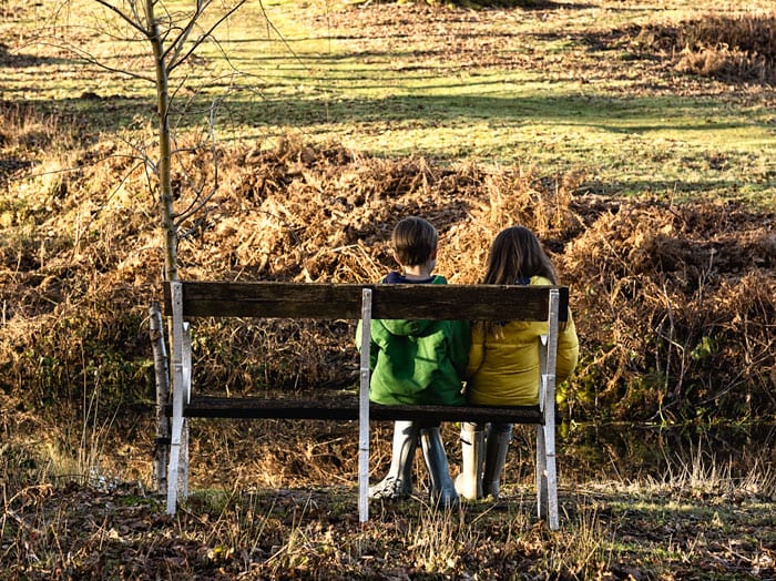 Luce and Theo on bench from behind