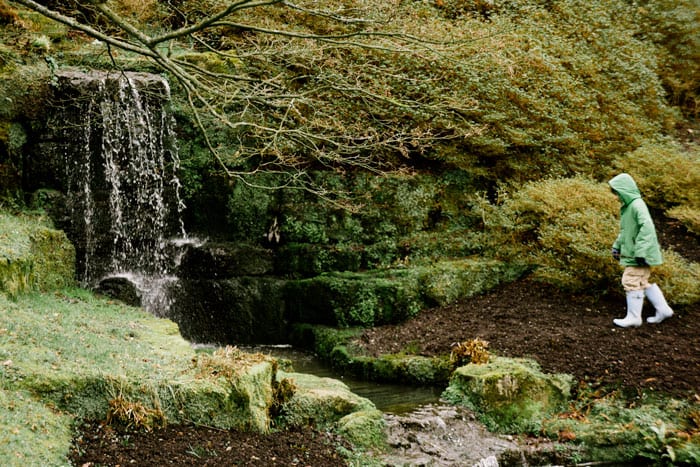 Theo by waterfall at Wakehurst