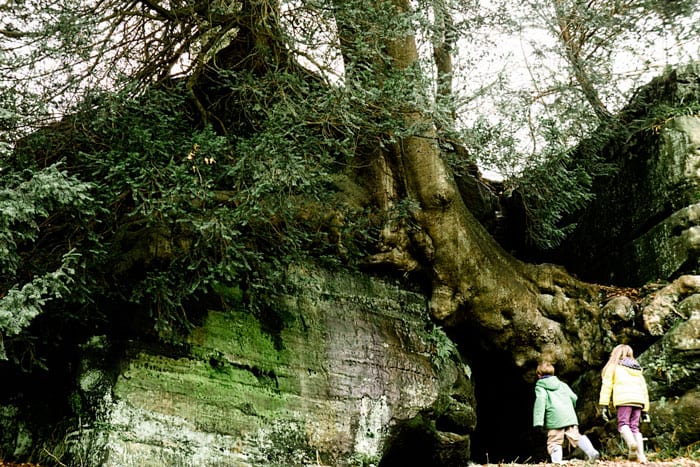 Luce and Theo by rock cave at Wakehurst