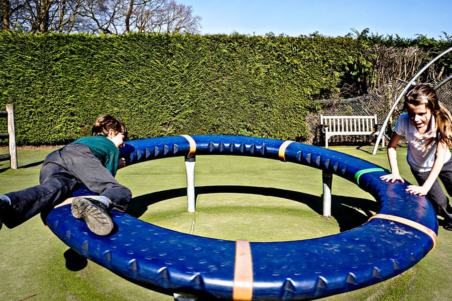 Luce and Theo on playground donut