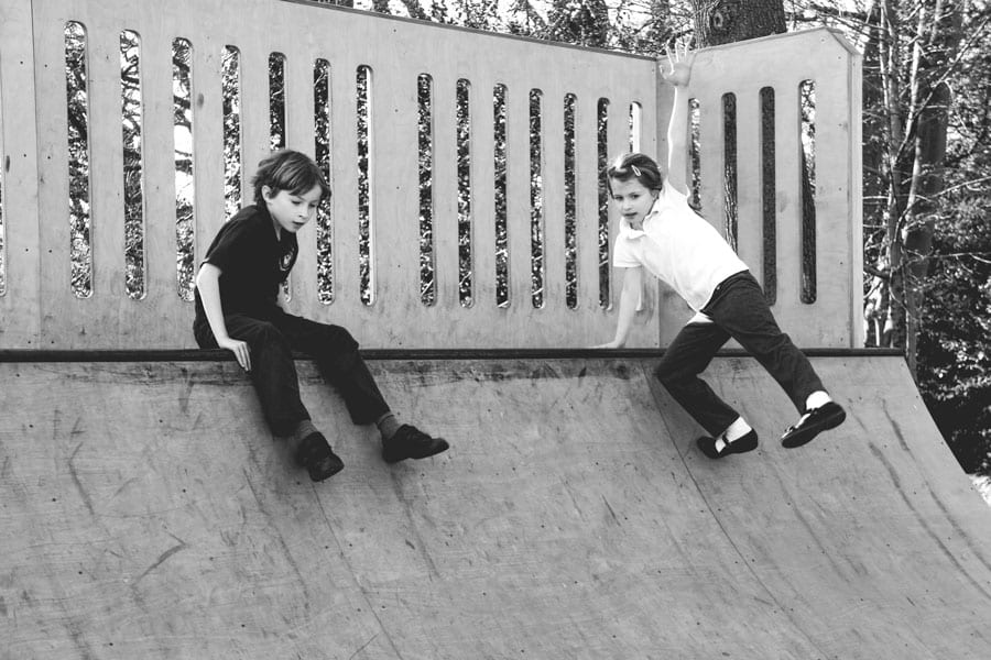 Luce and Theo at top of skateboard ramp