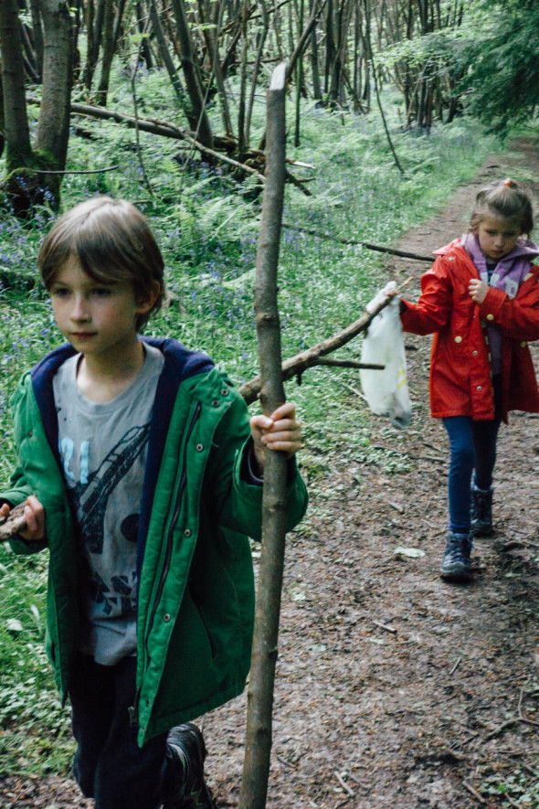 Carrying long sticks on woodlands scavenger hunt