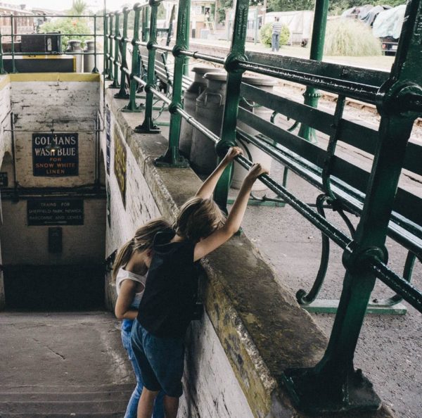 Luce and theo playing on stairs of platform