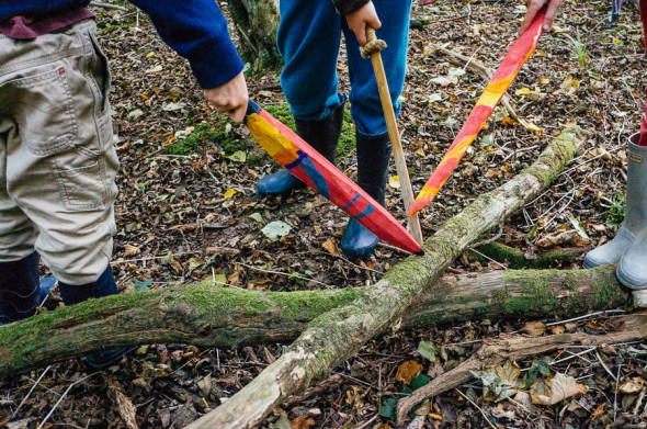 Kids painted swords in woods