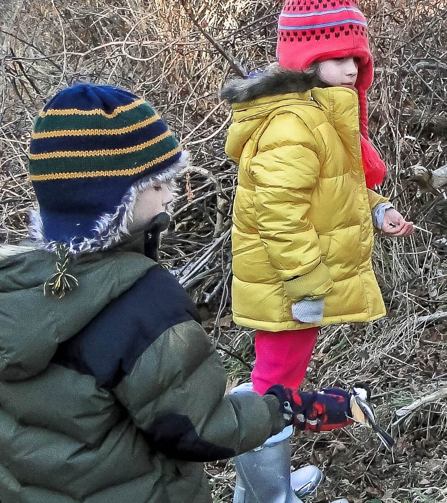 Kids bird watching bird in the hand