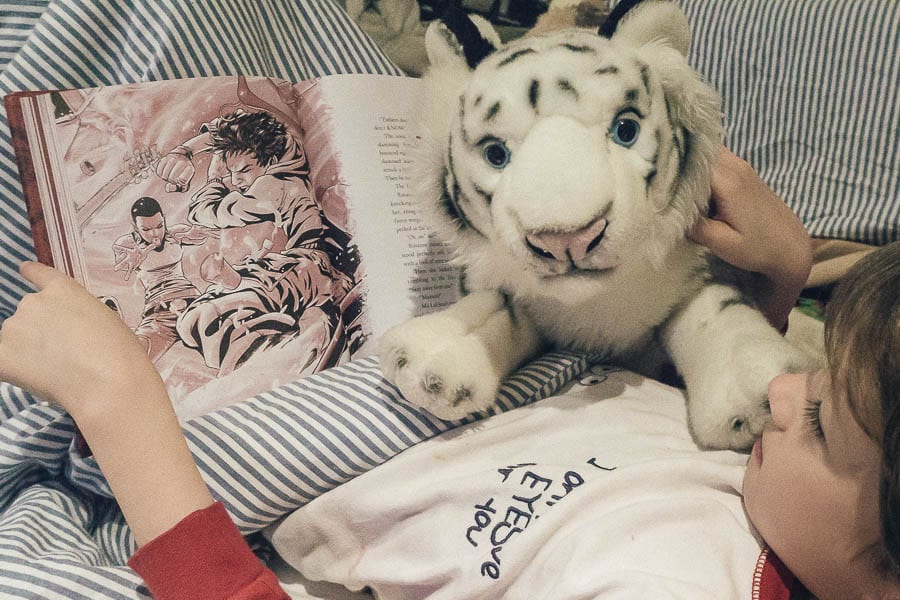 Zodiac reading in bed with tiger