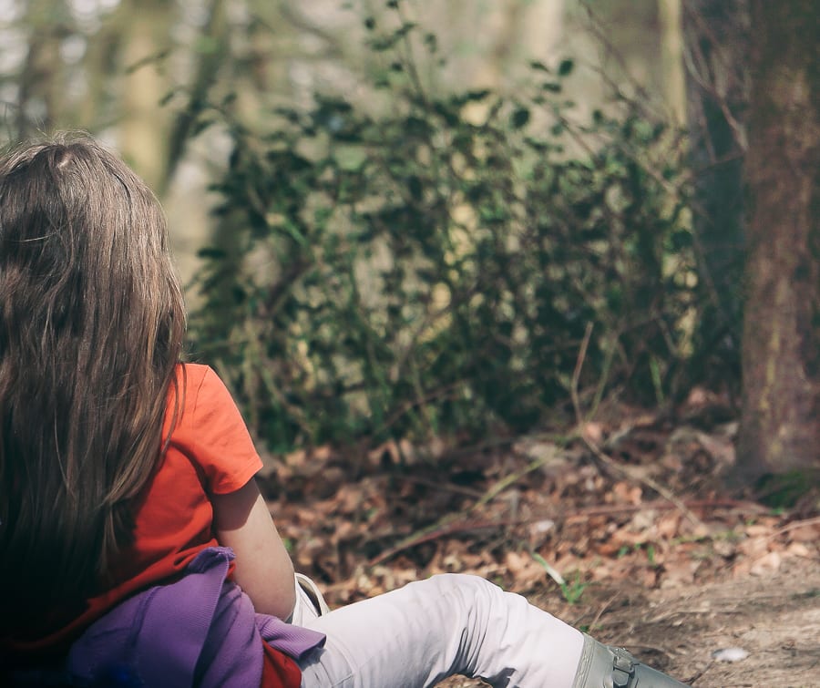 Spring Picnic child sitting in woods